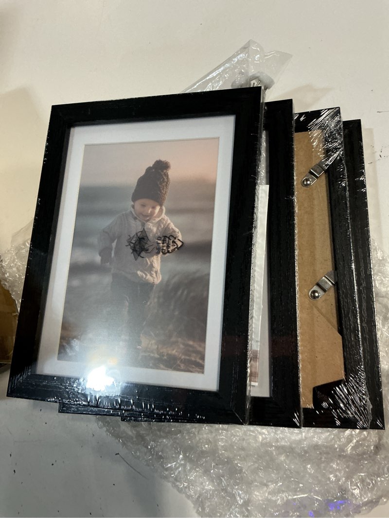Condition photo showing New/Like New for kinlink 5x7 picture frame black wood set of 4, wooden photo frame matted 4x6 with plexiglass for 4x6 with mat or 5x7 without mat for table and wall display black wood 5x7