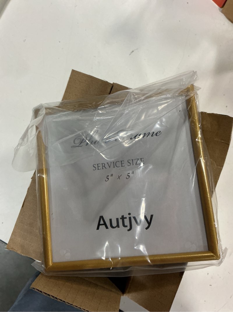 Condition photo showing Good Condition for 5x5 picture frames gold - brushed brass modern simple thin aluminum metal photo frame with hd real glass, display for tabletop and wall collage. (2 pack) 5x5 brass