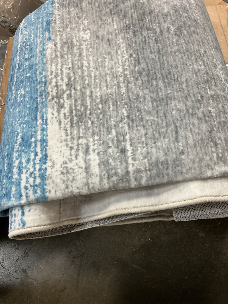 Condition photo showing Good Condition for garvee 5' x 7' blue and gray ombre washable indoor outdoor area rug