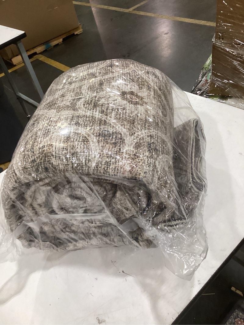 Condition photo showing As Is for this is a nourison arctic collection area rug, featuring a distressed, faded-look design in neutral gray and beige tones.