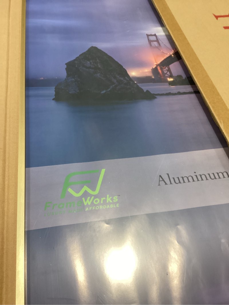 Condition photo showing Good Condition for FrameWorks 24x36 Brushed Aluminum Poster Frames – Modern Brushed Metal Design w/Shatterproof Plexiglass, Perfect for Posters, Artwork, Paintings, Wall Displays – Home or Office Decor, Gold - 1 Pack Gold 24"x36" (1 Pack)