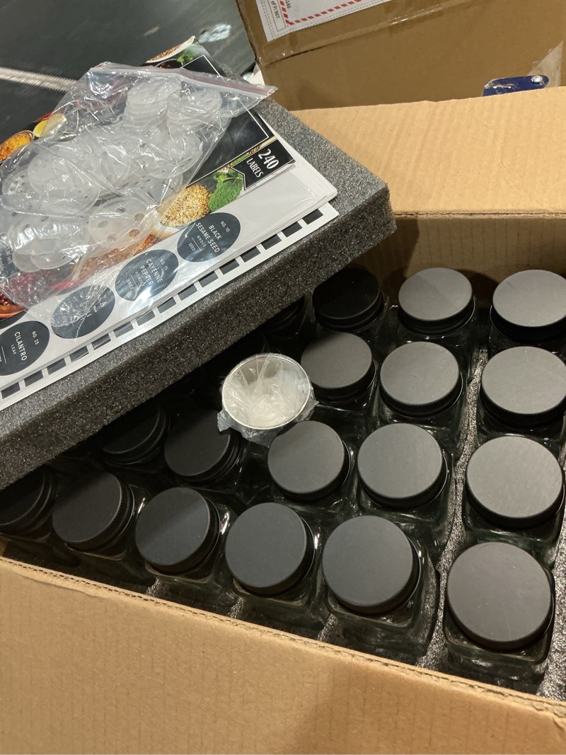 Condition photo showing Good Condition for glass spice jars with label and black aluminum lids (24 x 4oz) spice containers with 240 labels, shaker inserts, steel funnel, empty square seasoning organizer (black aluminum lid)