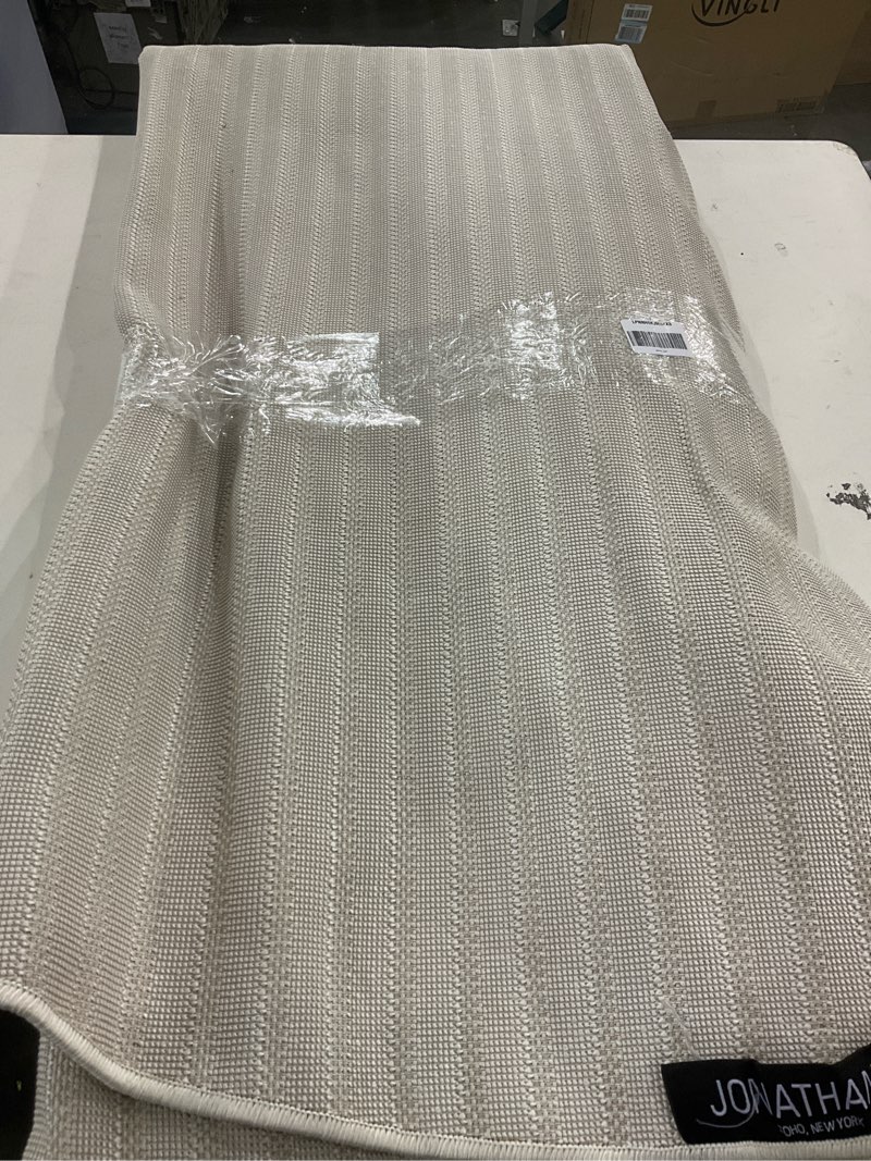 Condition photo showing As Is for JONATHAN Y Aarhus High-Low Striped Ivory/Cream 9' Round Indoor/Outdoor Area Rug, Minimalist Geometric, Pet Friendly, Non-Shedding, Stain Resistant, Easy-Cleaning for Backyard, Patio (SCN102B-9R) Ivory/Cream 9' (Round)