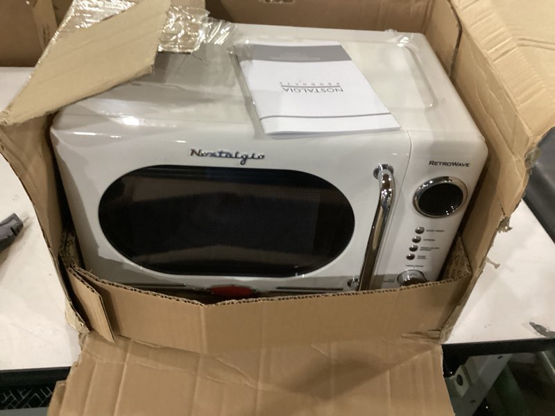 Condition photo showing Good Condition for Nostalgia Retro Compact Countertop Microwave Oven - 0.7 Cu. Ft. - 700-Watts with LED Digital Display - Child Lock - Easy Clean Interior - Ivory Retro Classic 0.7 Cu. Ft. Ivory