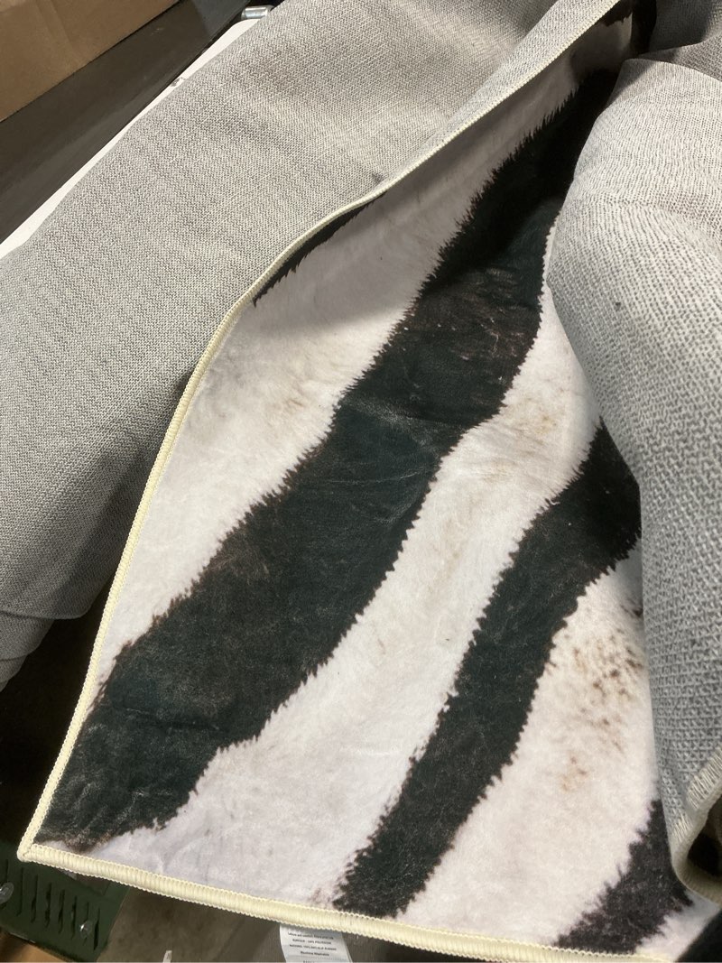 Condition photo showing Good Condition for amearea large zebra rug for living room, 8x10 feet animal print rug for bedroom, premium black and white machine washable area rug, faux fur zebra skin non-slip rugs carpet for dining room office 8x10 feet zebra-black and white