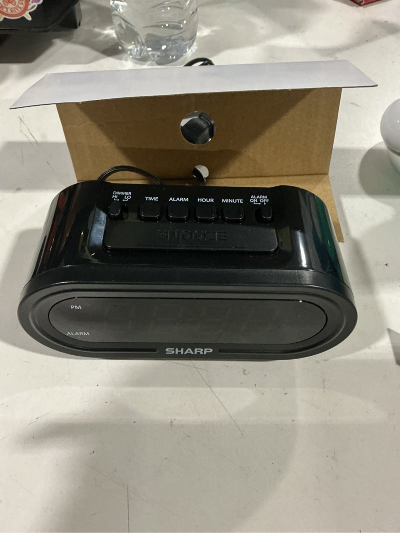 Condition photo showing As Is for sharp digital alarm clock with accuset - automatic set, black with white led display