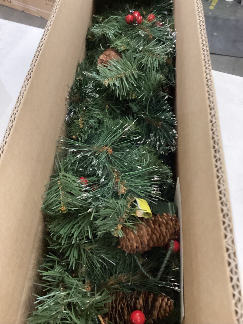 Condition photo showing Good Condition for National Tree Company 9 ft Pre-Lit Crestwood Spruce Artificial Christmas Garland, Christmas Decoration with Glitter, Pinecones, Red Berries, 50 Clear Lights, 180 Tips, Green Plug In Tree