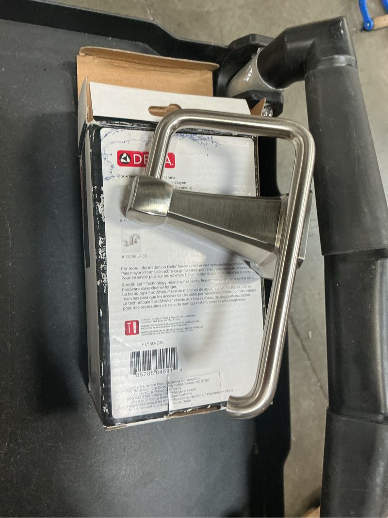 Condition photo showing As Is for delta flynn brushed nickel wall mount single post toilet paper holder