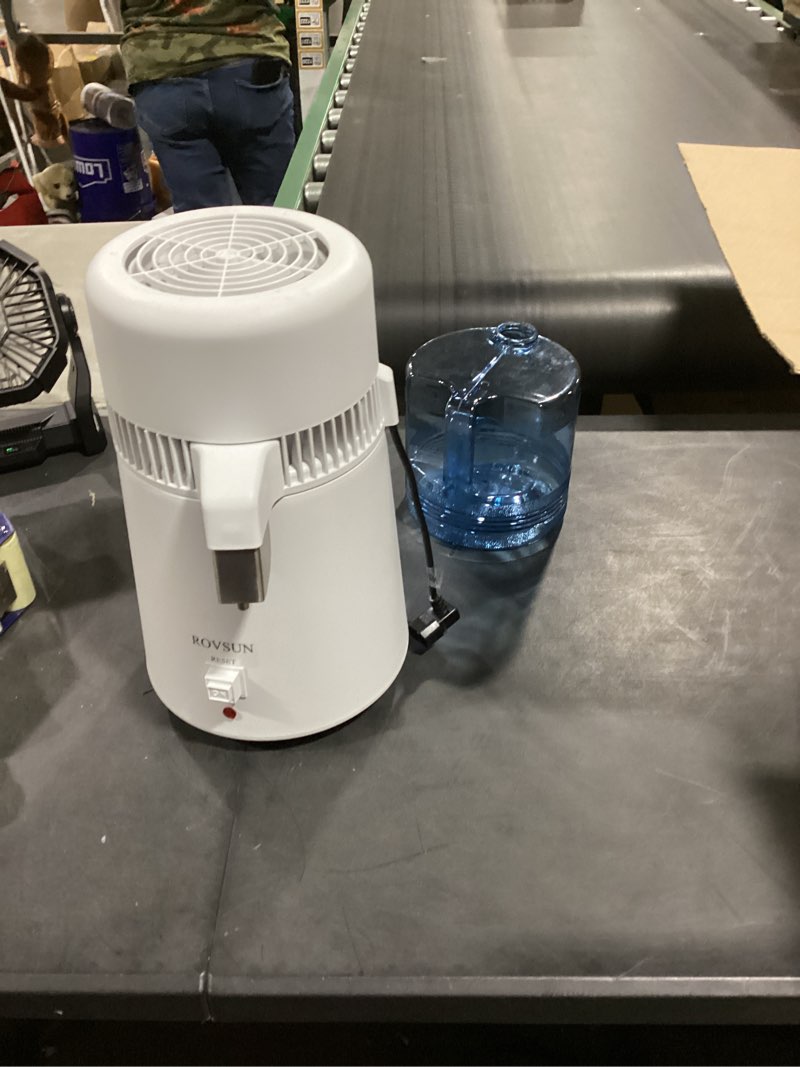 Condition photo showing As Is for rovsun ?upgraded? 1.1 gallon/4l water distiller countertop distilled water machine with flame-retardant material, bpa-free container & stainless steel interior, 750w distilled water maker purifier 4l-white