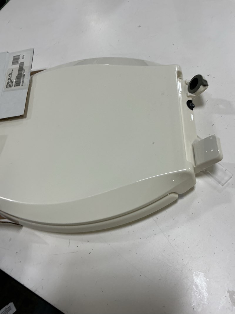 Condition photo showing As Is for kohler cachet® nightlight soft close toilet seat elongated, readylatch®, grip-tight hardware, biscuit biscuit elongated night light