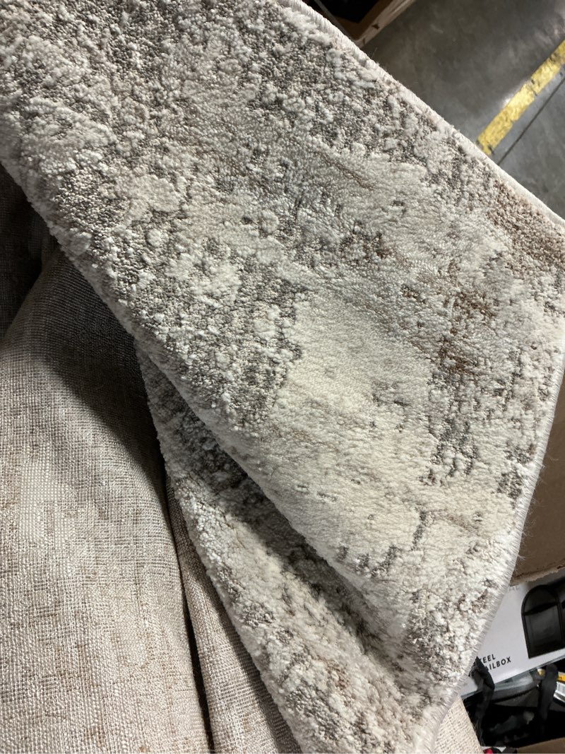 Condition photo showing As Is for origin 21 8 x 10 (ft) beige indoor abstract area rug