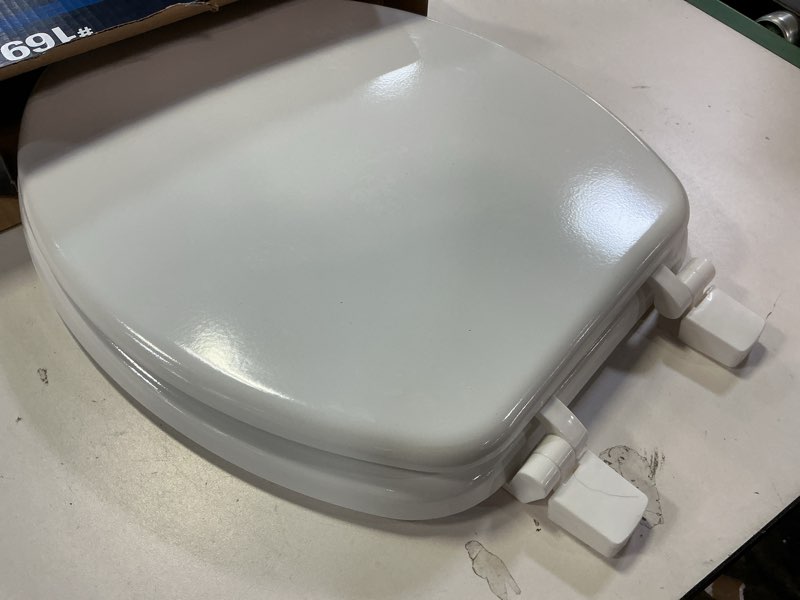 Condition photo showing As Is for  Project Source Wood White Elongated Toilet Seat