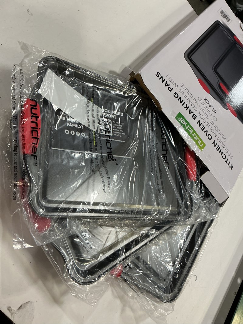 Condition photo showing New/Like New for NutriChef 3-Piece Nonstick Kitchen Oven Baking Pans - Premium & Stylish Non-Stick Steel, Commercial Grade Restaurant Quality Metal Bakeware with Red Silicone Handles - Easy to Clean, NCSBS3S 3-Piece Set