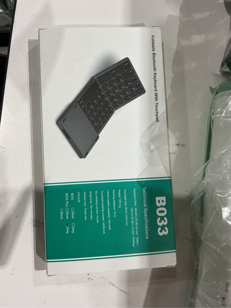 Condition photo showing New/Like New for rock&rown foldable bluetooth keyboard, pocket size portable wireless keyboard with touchpad for mac os,android, windows, linux, pc, tablet, with rechargeable li-ion battery-dark gray