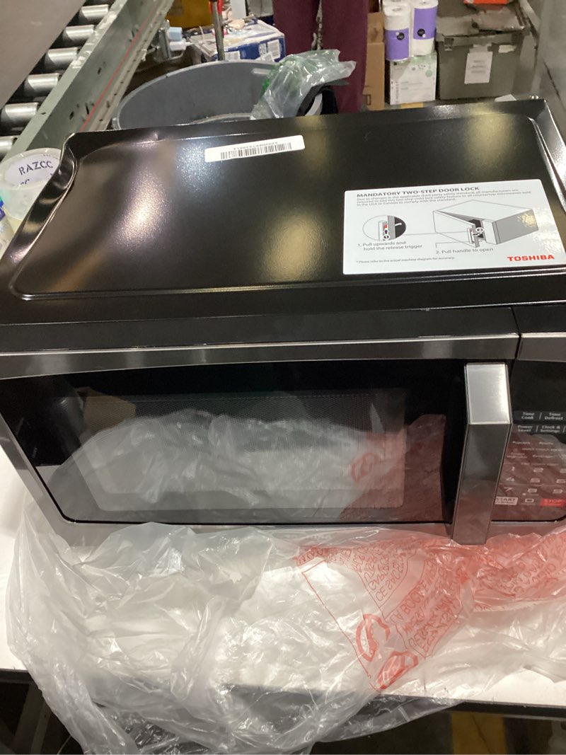 Condition photo showing As Is for toshiba ml-em09pa(bs) small microwave oven with 6 auto menus, mute function & child lock, led lighting, 0.9 cu ft, 10.6 inch removable turntable, 900w, countertop, black stainless steel advanced-0.9 cu ft-900w-black stainless steel
