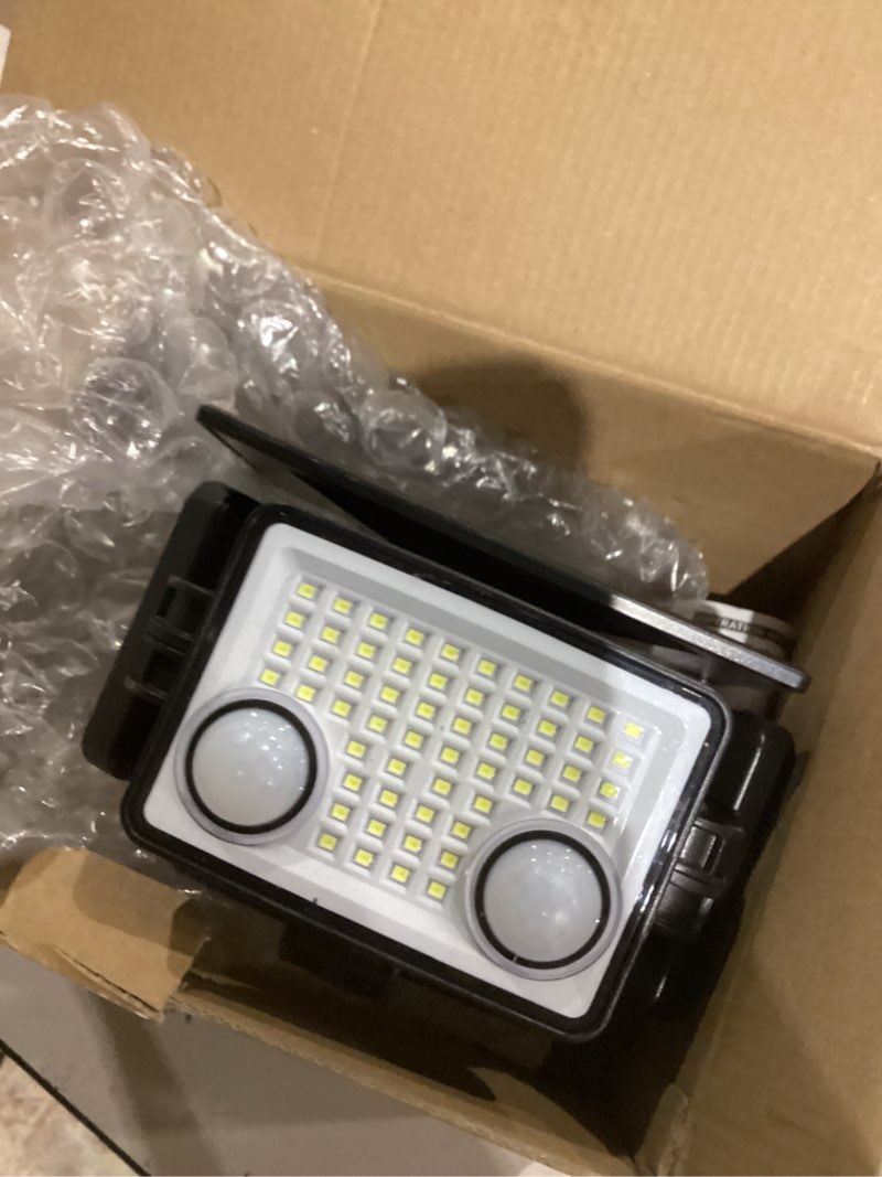 Condition photo showing As Is for solar outdoor lights - 3000lm 188 led motion sensor outdoor lights, 4 heads security light,ip65 waterproof, easy install,270°wide angle flood wall light with 3 modes for backyard yard (2 pack)