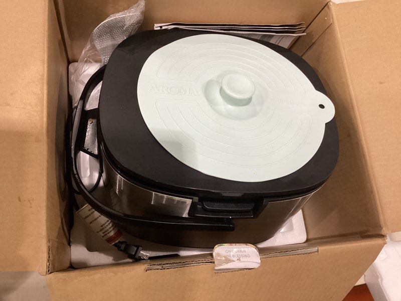 Condition photo showing As Is for aroma® 6-cup (uncooked)/ 12-cup (cooked) slow cook rice cooker and brown rice cooker with lift-out pot handles and silicone storage lid, pfas-free ceramic coating professional corecoat ceramic