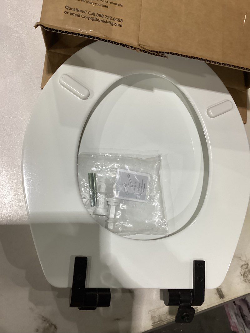 Condition photo showing As Is for Mayfair Bennett Toilet Seat with Matte Black Hinges, Slow Close Wood Seat, Secure Metal Hinges, Easy Install, Made in USA, Round, White Round Matte Black