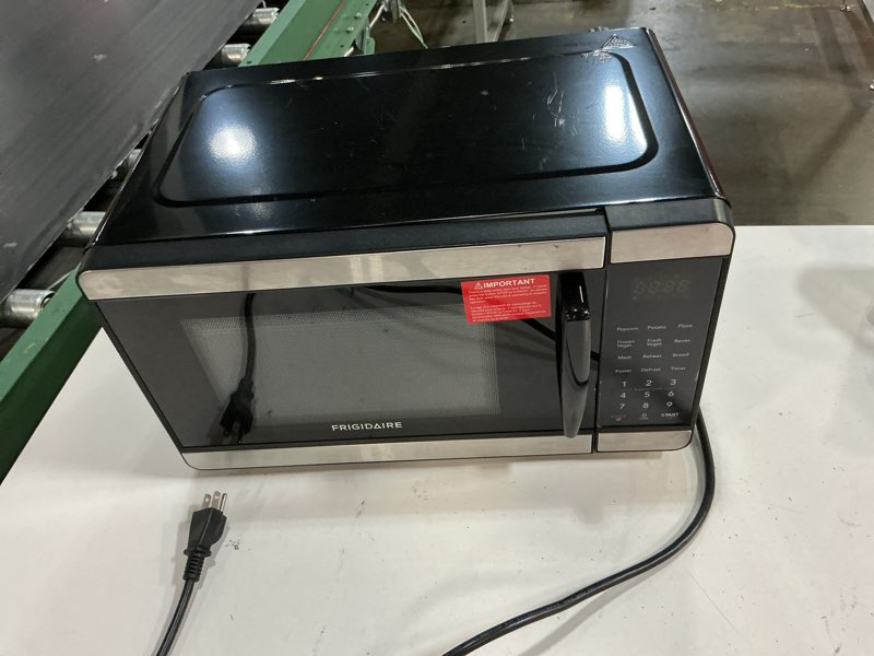 Condition photo showing As Is for frigidaire countertop microwave - digital control panel - 6 auto cooking settings - 10 power levels - child safety lock - 0.7 cu. ft., stainless steel silver