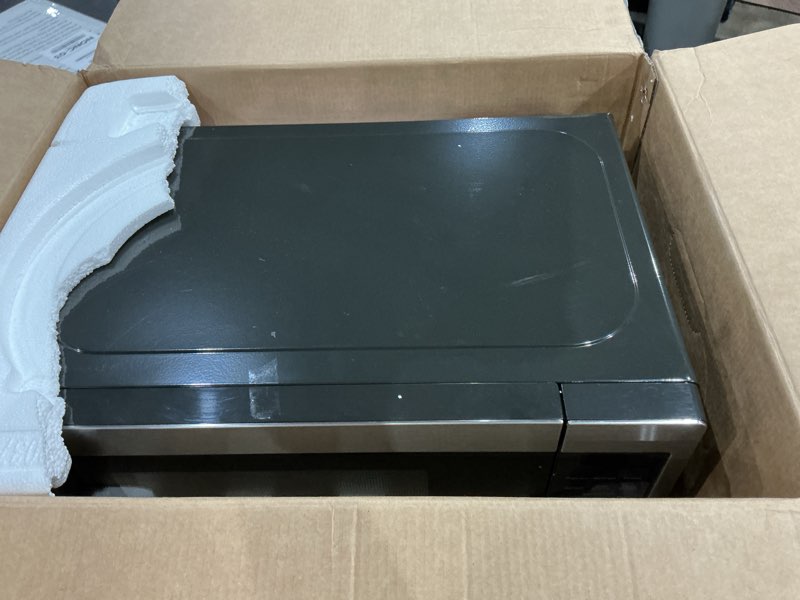 Condition photo showing As Is for ge - 0.7 cu. ft. countertop microwave with convenience cooking control - black stainless steel