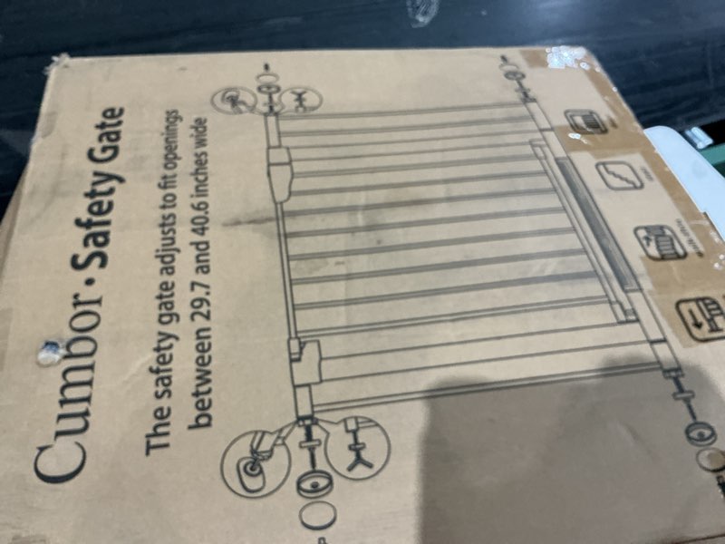 Condition photo showing As Is for cumbor. safety gate  the safety gate adjusts to fit openings between 29.7 and 40.6 inches wide