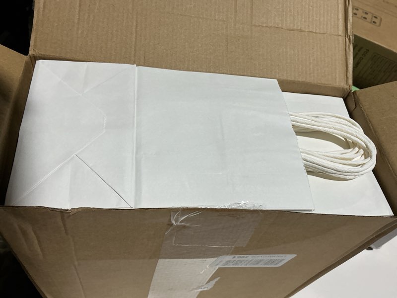 Condition photo showing Good Condition for XPCARE 200Pcs Paper Gift Bags 5.25x3.25x8.25'', Gift Wrap Bags with Handles White Kraft Paper Bags for Small Business Paper Bags Bulk for Birthday Party Favors Shopping Retail 1 Count (Pack of 200) White