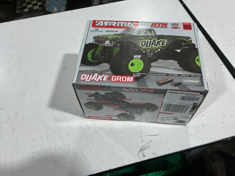 Condition photo showing As Is for arrma rc truck 1/16 quake grom 4x4 rtr brushed monster truck (battery & charger included), green, ar