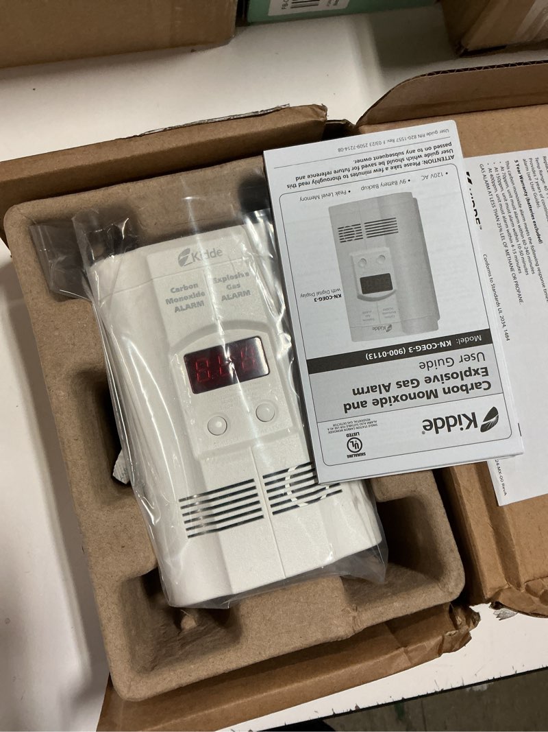 Condition photo showing New/Like New for kidde carbon monoxide + explosive gas, natural gas & propane alarm, plug-in with 9v battery backup, digital display, 85 db alarm, led status indicators, 3rd edition