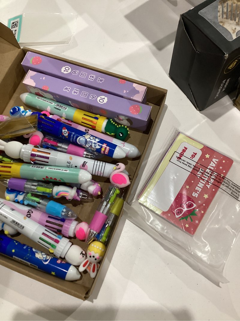 Condition photo showing Good Condition for MISSING SOME PENS 24 Set Valentine's Day Multicolor Pens with Cards Gift Set 12 Pcs 10 in 1 and 12 Pcs 4 In1 Cute Cartoon Ballpoint Pen for Galentines Day Friendship Exchange Gift Party Favors