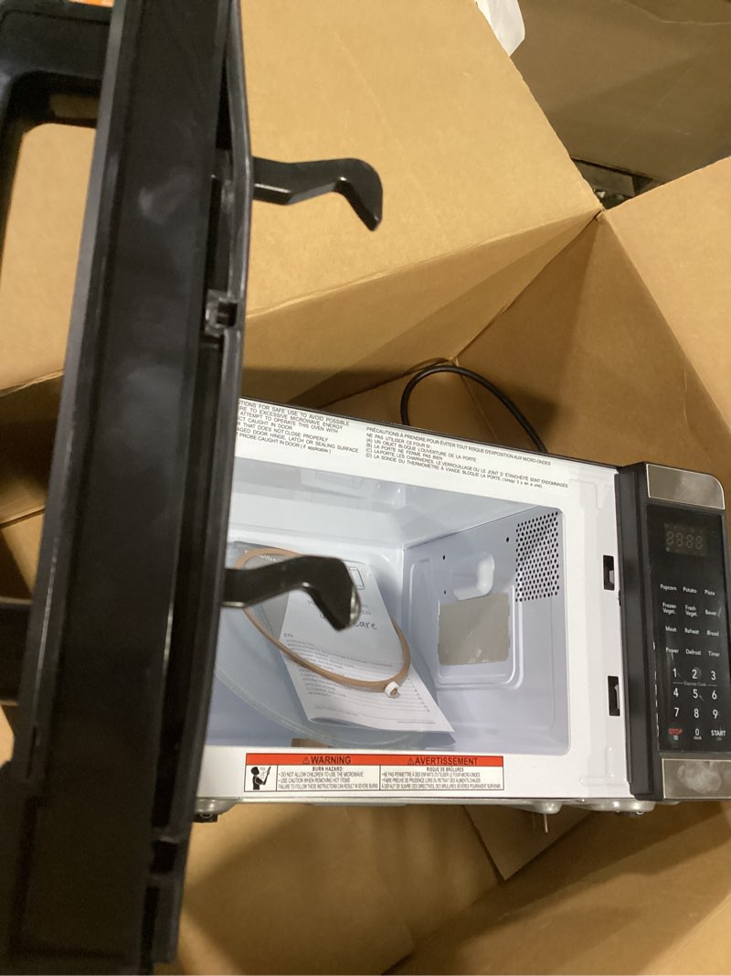 Condition photo showing As Is for frigidaire emw727 0.7 cubic foot microwave, stainless steel