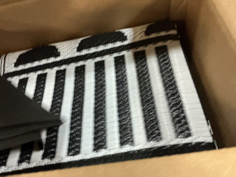Condition photo showing Good Condition for Waterproof Outdoor Rug 8x10ft, Boho Reversible Plastic Straw Mat for Patio RV Deck Porch Backyard Balcony Camping Picnic Beach Indoor Outdoor Carpet, Black&White A.bohemia | Black & White 8' x 10' (Rectangular)