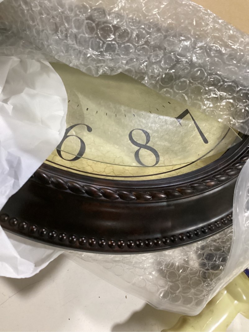 Condition photo showing As Is for hylanda wall clock, bronze silent non ticking classic battery operated clocks, decorative for living room, bedrooms, kitchen, office (16 inch) a_bronze 16"