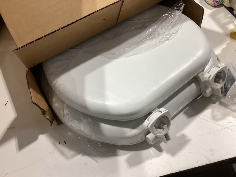 Condition photo showing Good Condition for mayfair padded toilet seat, cushioned soft vinyl over wood core seat, secure hinges, easy clean, made in usa, round, white round white toilet seat