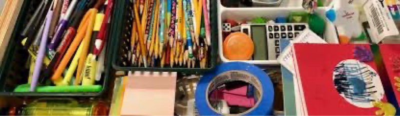 mixture of office and school supplies. paper, pencils, notebooks, etc.