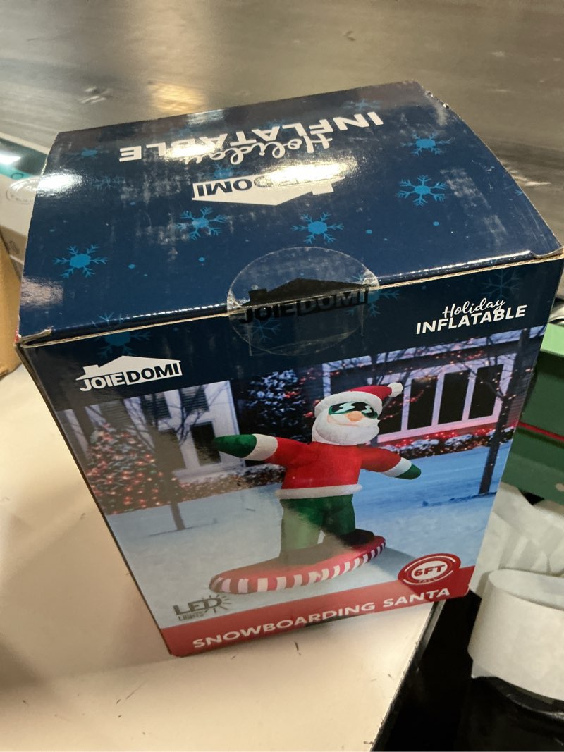 Condition photo showing New/Like New for JOIEDOMI 6FT Tall Christmas Inflatables Outdoor Decorations, Inflatable Snowboarding Santa, Blow Up Yard Decoration with Build-in LED for Xmas Party Outdoor, Yard, Garden, Lawn Decor