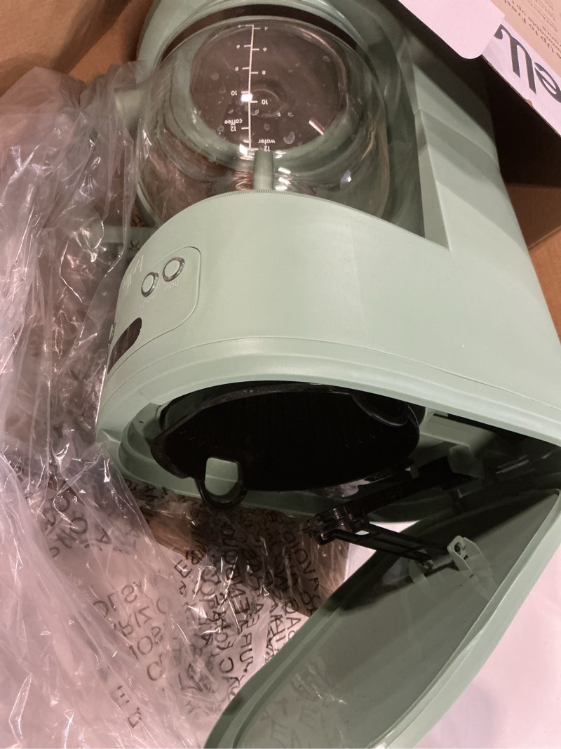 Condition photo showing As Is for bella 12 cup programmable coffee marker, reusable dishwasher safe accessories, easy lcd diaply, auto shutoff, 900 watt, seaglass