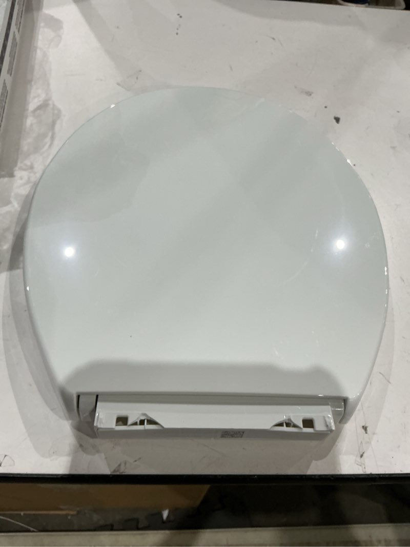 Condition photo showing As Is for kohler 20111-0 brevia, slow close toilet seat, round toilet seat, grip-tight bumpers quick-attach hardware, white