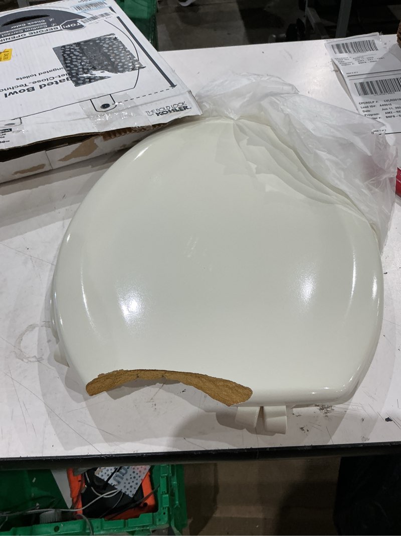 Condition photo showing As Is for kohler stonewood quiet-close, elongated toilet seat soft close, durable wood, easy installation, universal fit, home essentials, biscuit finish, k-20466-96 biscuit elongated double-hinge