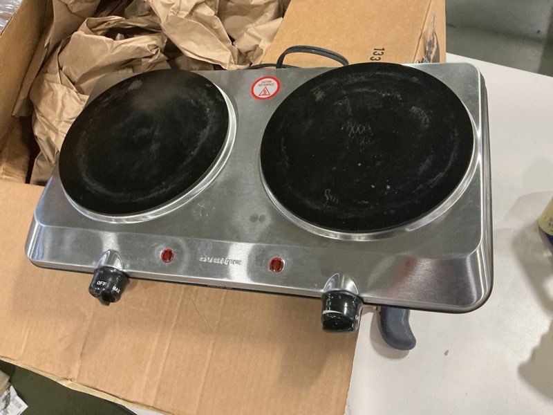 Condition photo showing As Is for OVENTE BGI102S Countertop Infrared Double Burner, 1700W Electric Hot Plate and Portable Stove with 7.75" and 6.75" Ceramic Glass Cooktop, 5 Level Temperature Setting and Easy to Clean Base, Silver