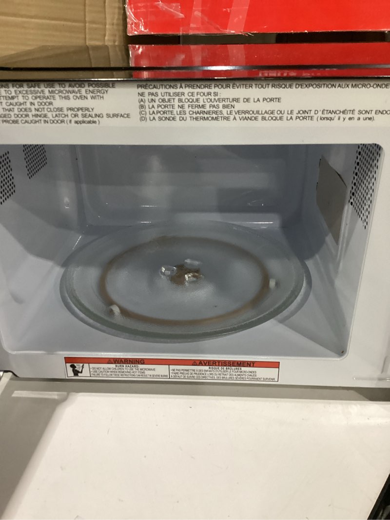 Condition photo showing As Is for FRIGIDAIRE 0.7 Cu. ft. New Countertop Microwave Oven - Black