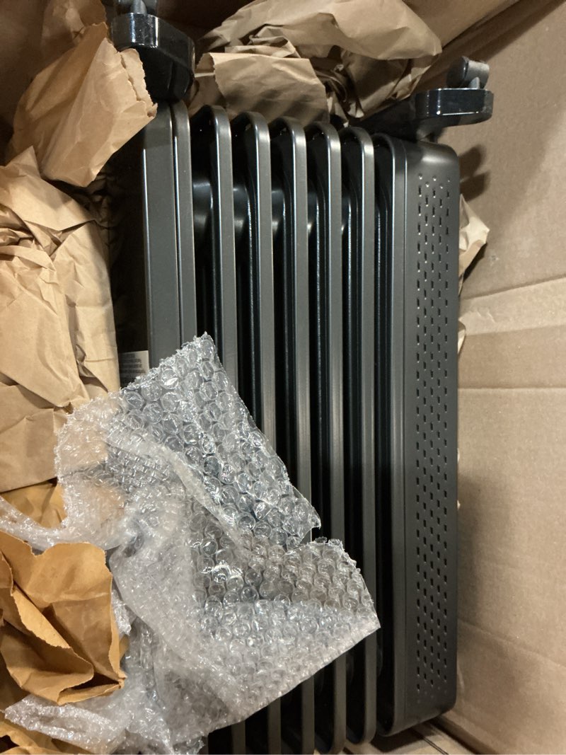 Condition photo showing As Is for zafro oil filled radiator heater, 1500w energy saving space heater with curved fin design, smart touch screen, eco mode & 24h on/off timer, tip-over & overheat protection for bedroom office use, black