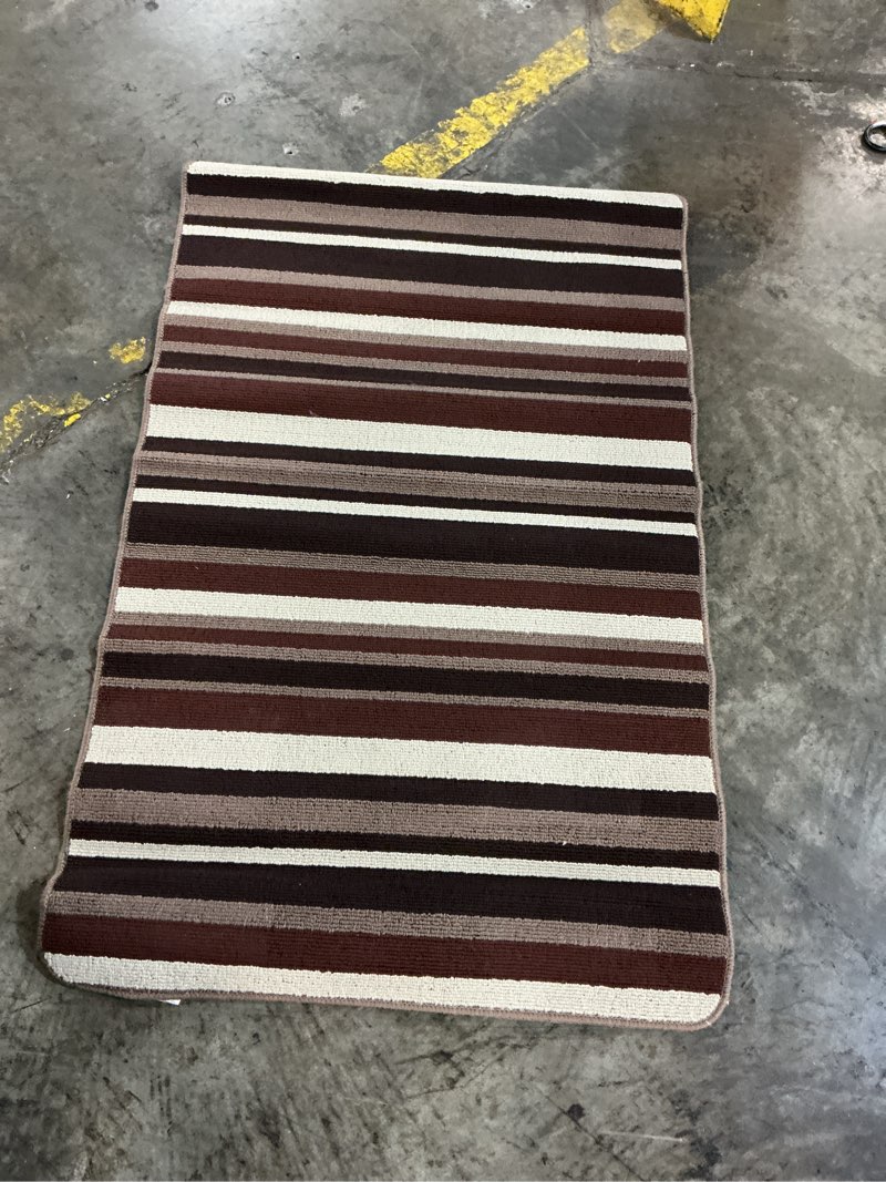 Condition photo showing As Is for sonoma cabernet  doormat 2 ft. x 4 ft. striped polypropylene accent rug