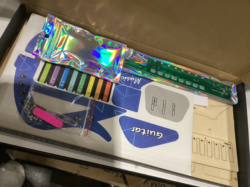 Condition photo showing New/Like New for Similar to stock photos SkilLify Guitar Toy for Kids, 3-in-1 Musical Instrument Toy, Keyboard Piano & Bass Sounds, DIY Electronic Wooden Play Guitar Kit for 5-12 Year Old Children Boys Girls Gifts(Red or blue)