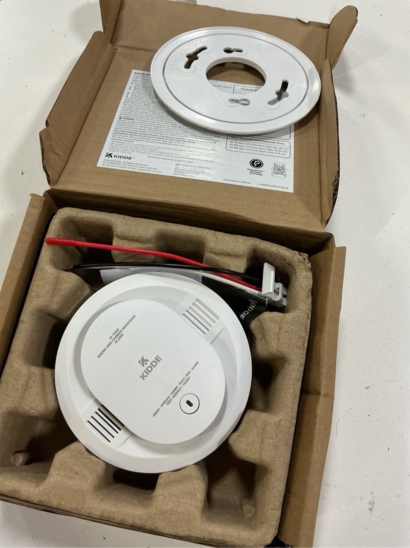 Condition photo showing As Is for kidde smoke and carbon monoxide detector, hardwired with 10-year battery backup, led status lights, interconnected, 85 db alarm, 5 inches, 30cua10, 1 pack
