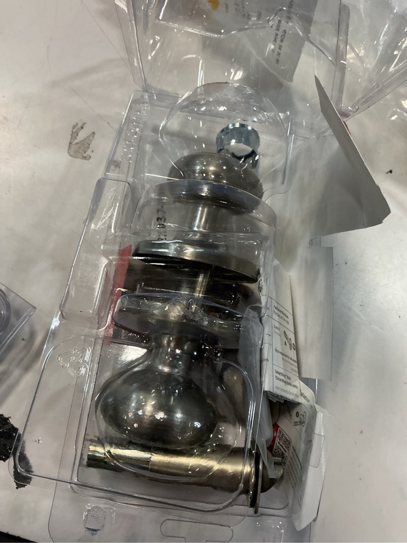 Condition photo showing As Is for kwikset cove satin nickel smartkey exterior keyed entry door knob with antimicrobial technology