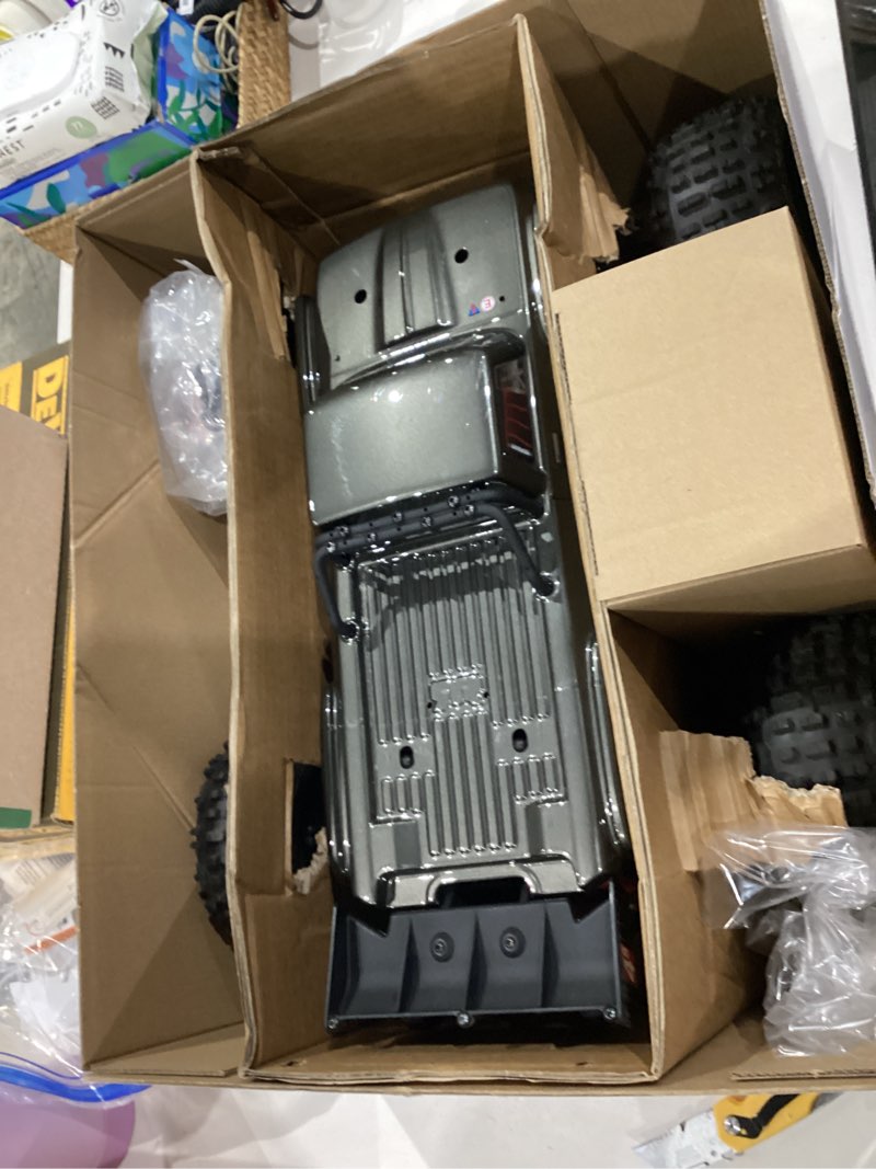 Condition photo showing As Is for arrma rc truck outcast 4x4 4s blx 1/10th 4wd stunt truck rtr (battery and charger not included), gunmetal, ara4410v2t3