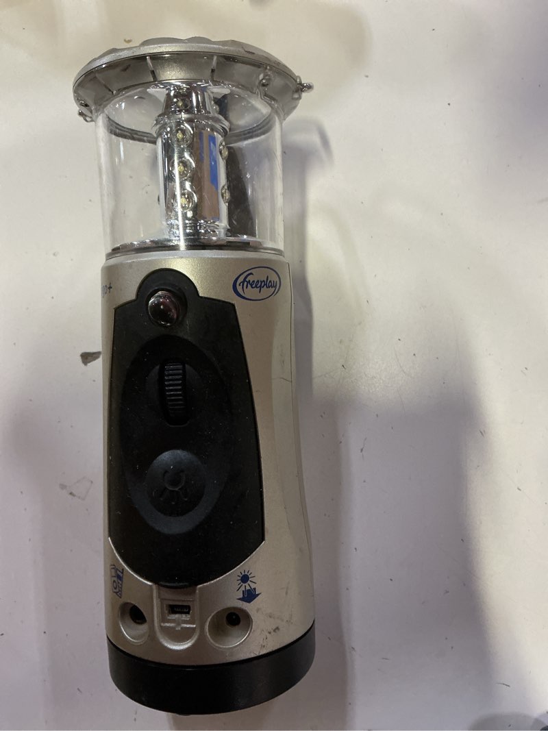 Condition photo showing As Is for freeplay indigo windup lantern