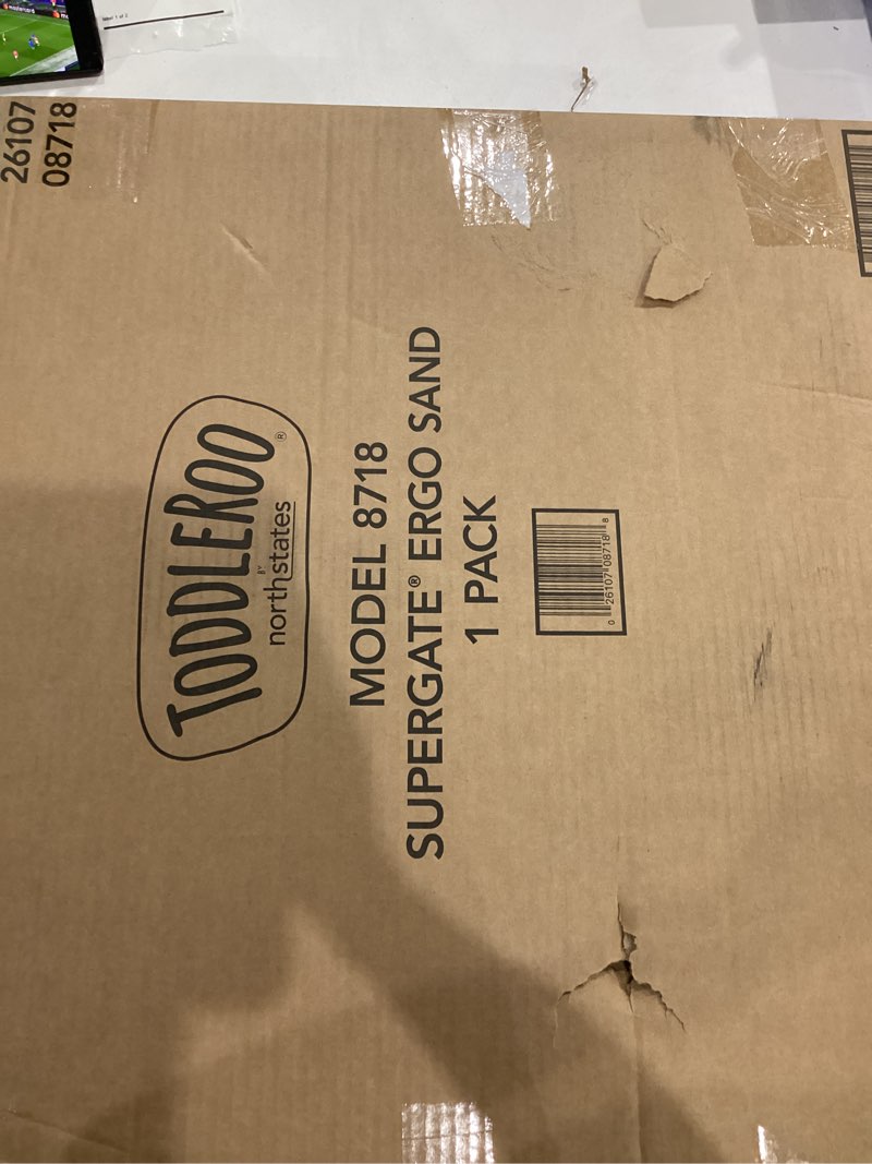 Condition photo showing As Is for Toddleroo by North States - Supergate Ergo Baby Gate: Plastic Baby Gate for Stairs & Doorways - Adjustable Indoor Safety Gate - Made in USA - 26 to 42 Inches Wide - 26 Inches Tall - Sand