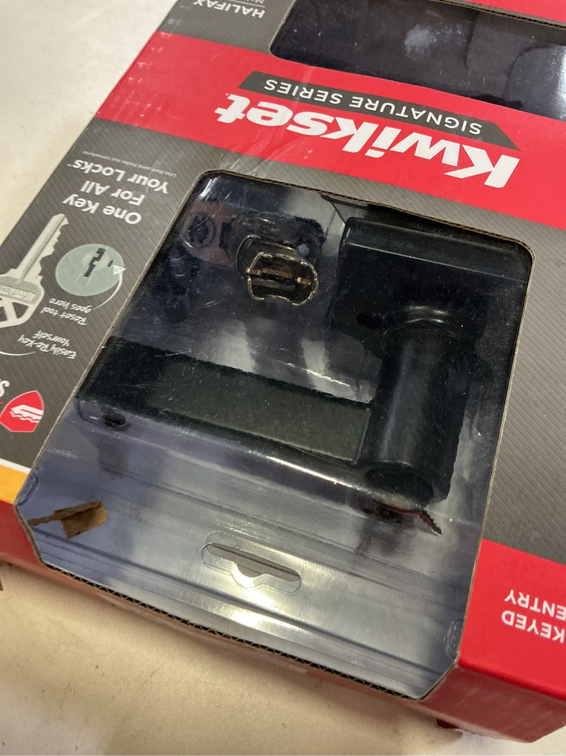 Condition photo showing As Is for kwikset halifax matte black entry door knob 2-3/4 in.