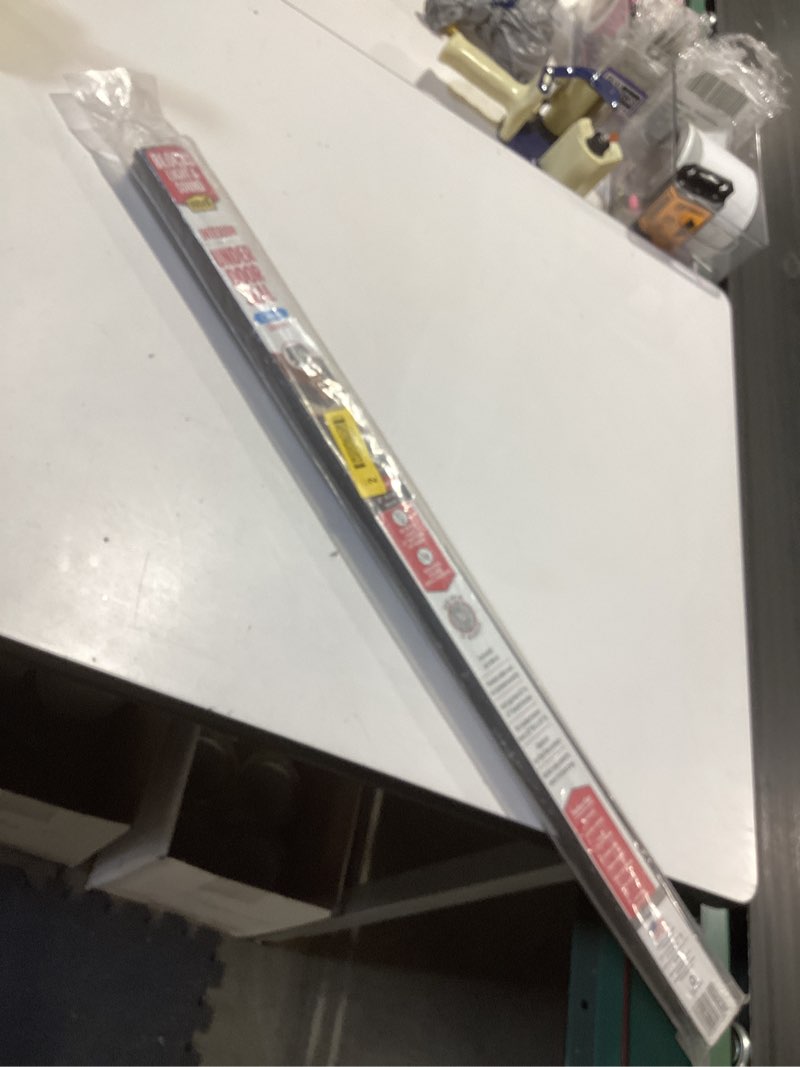 Condition photo showing As Is for m-d building products vinyl cinch u-shape door bottom seal, slide-on weatherstripping draft stopper, easy to install, fits 32” x 1-3/8” doors, fills 1/2”- 1-1/2” gaps, 43399, brown brown 32 inch 1
